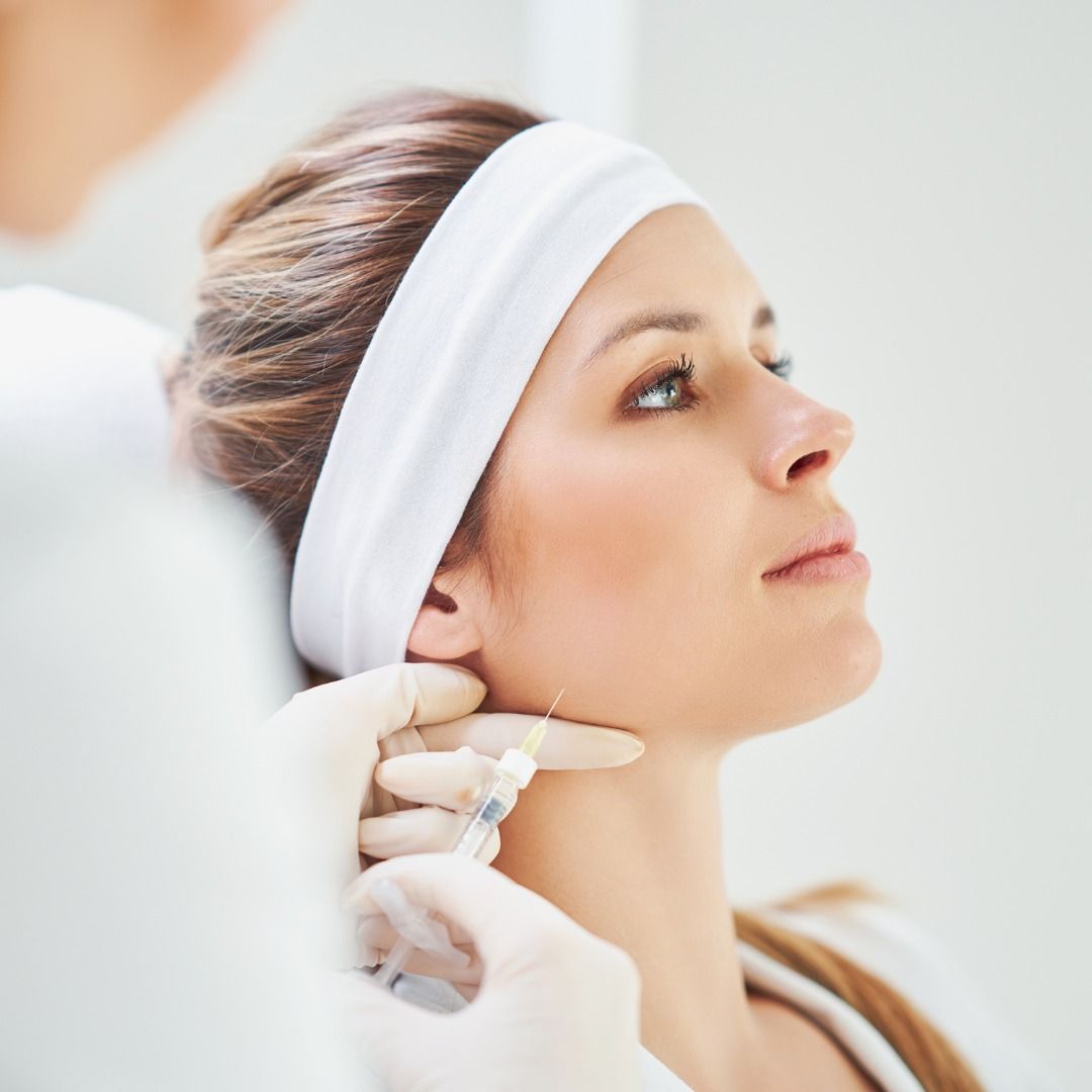 Woman receiving facial treatment with injection.