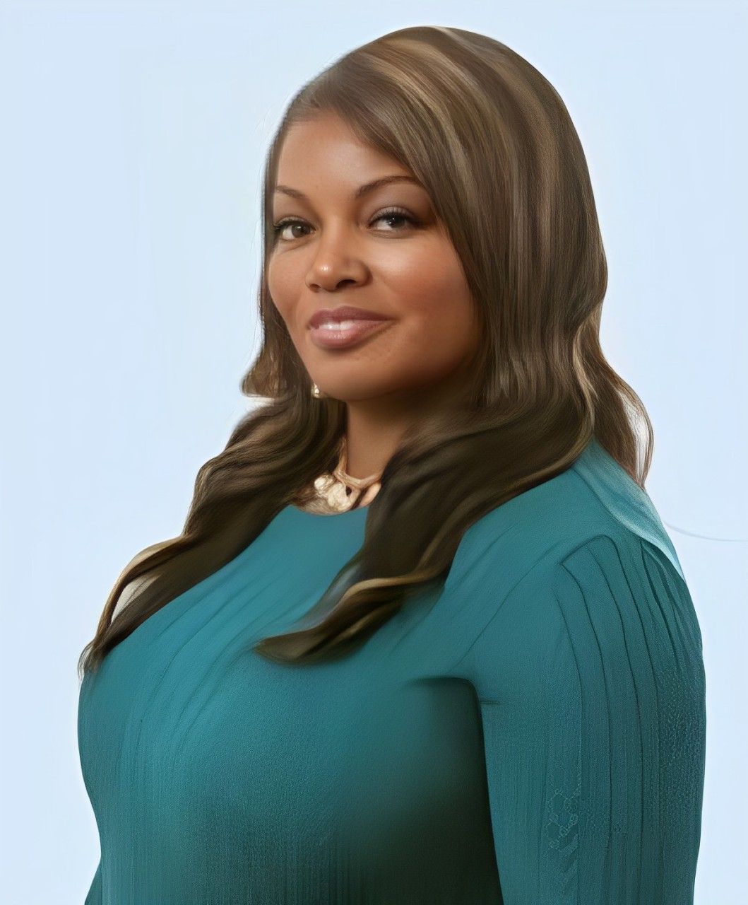 Professional woman in a teal blouse, smiling.