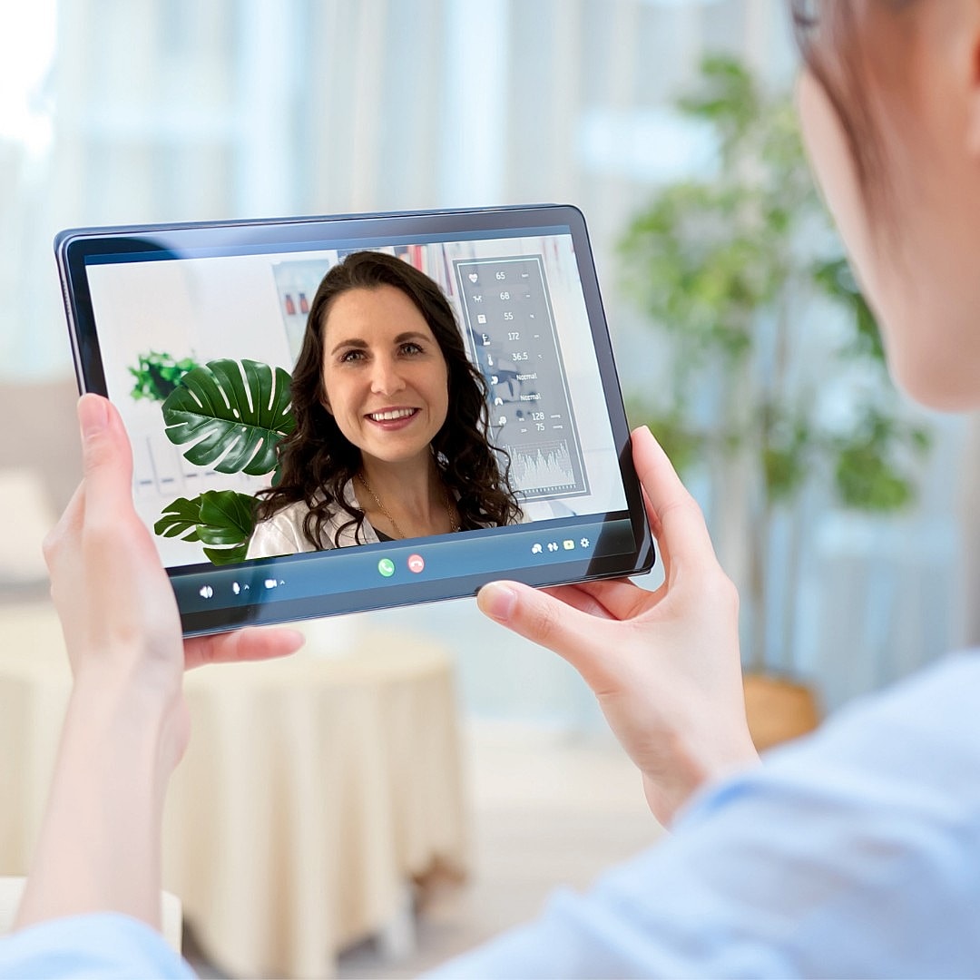 Woman on video call using a tablet device.